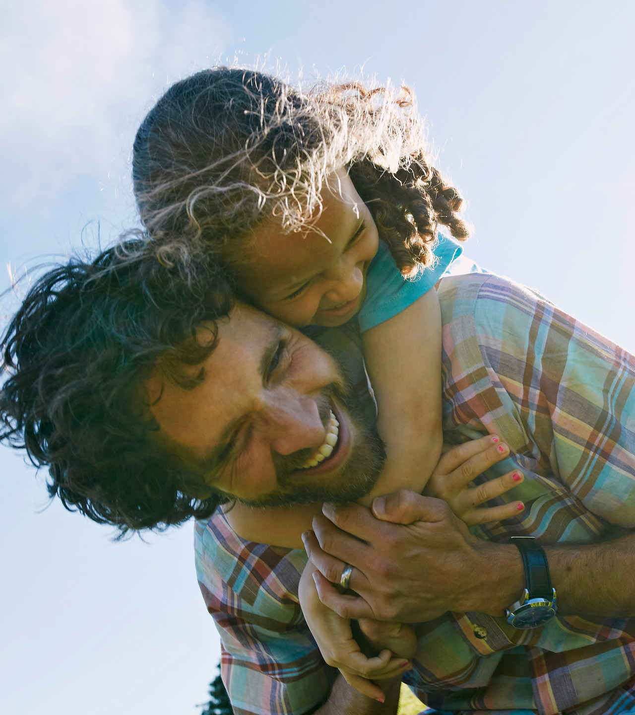 Father carrying a child outdoors