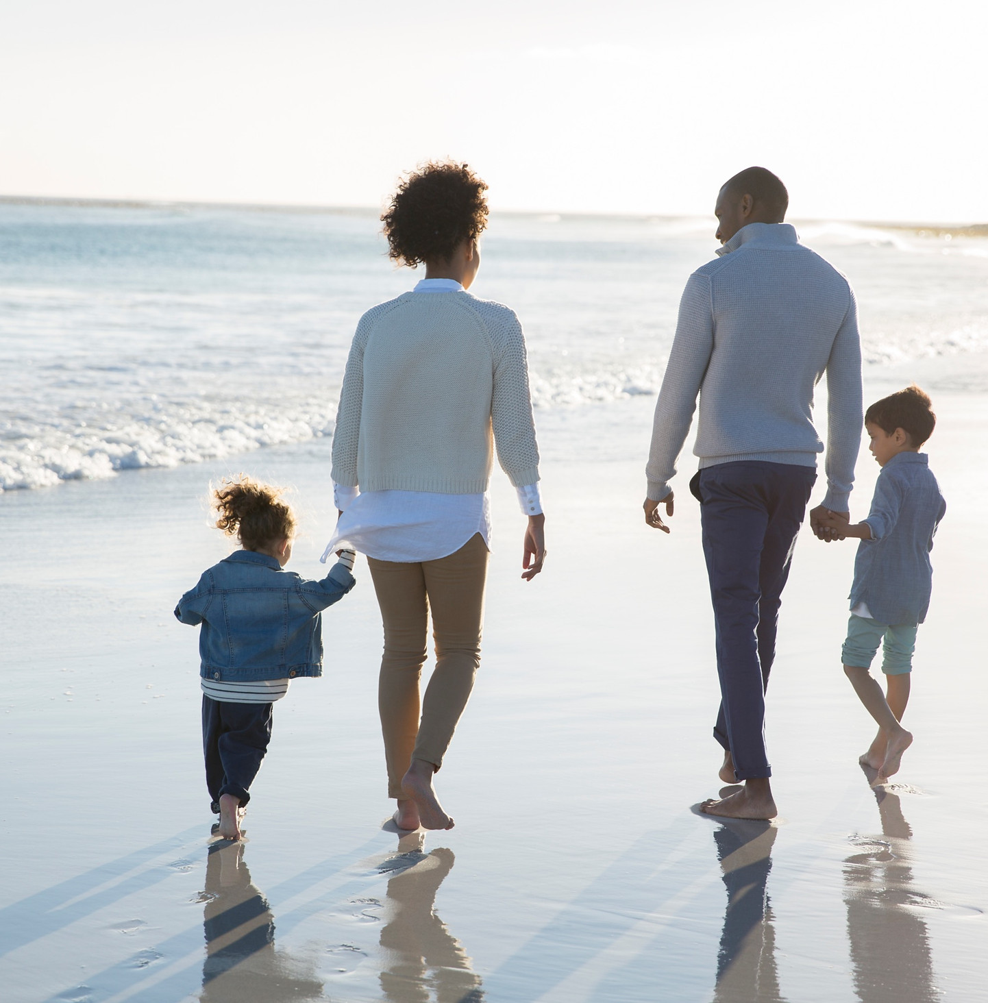 Family walking together on the beach